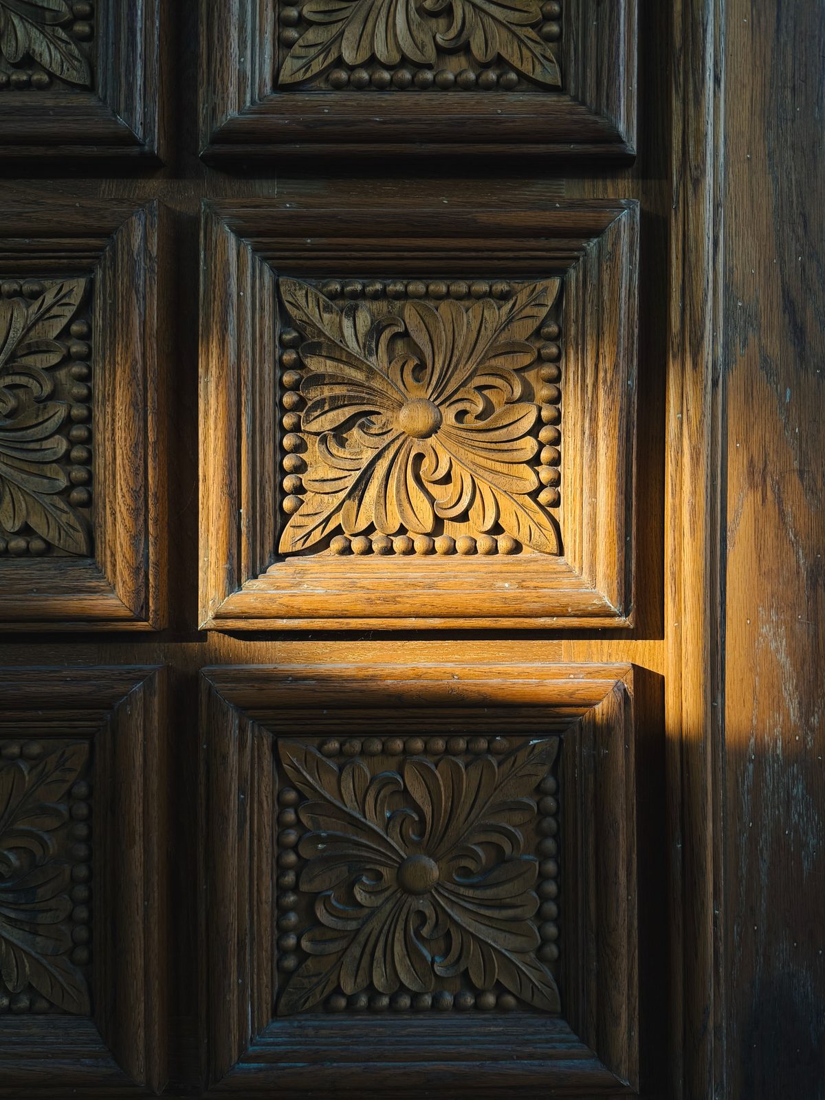 Carved floral relief on a panelled timber door